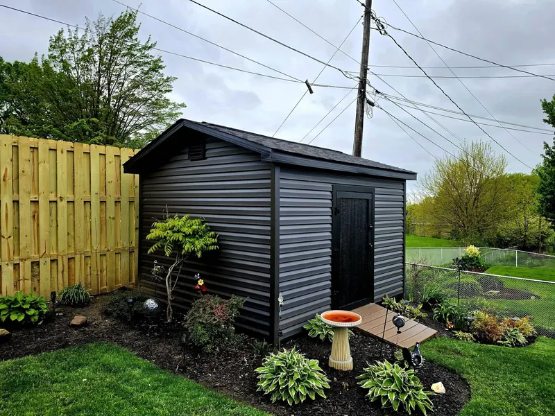 Dark horizontal siding on a backyard outbuilding